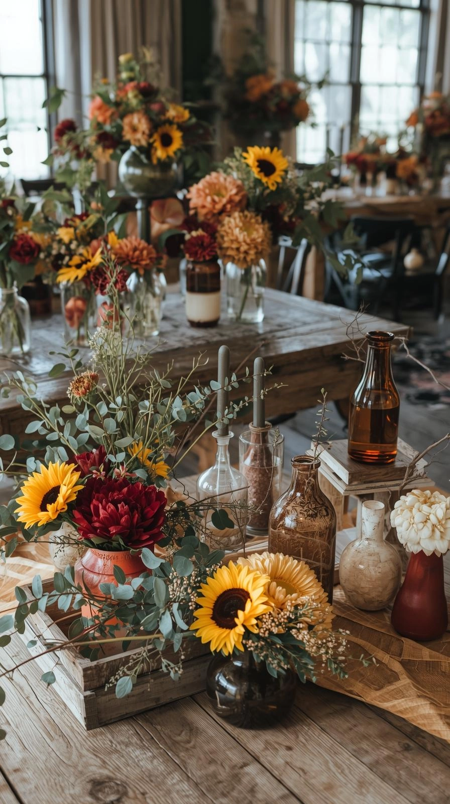 Fall baby shower decorated with sunflowers, dahlias, mums, and eucalyptus in rustic vases.